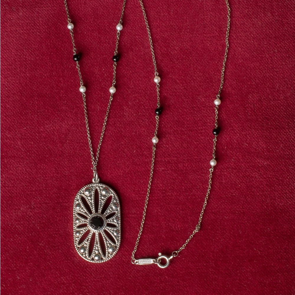 Tiffany and Co. Zeigfeld Collection silver,pearl,and onyx Daisy Pendant.